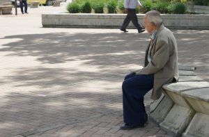 Ein alter Mann alleine auf einer Betonbank in einem Park, Stichwort Sozialleben. (c) Pixabay.com