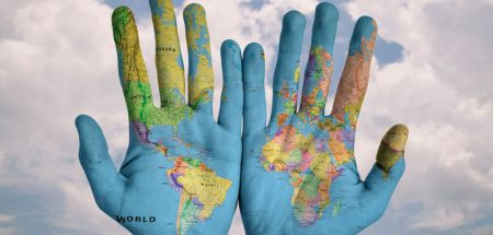 Zwei Hände, auf denen eine Weltkarte zu sehen ist. (c) Pixabay.com
