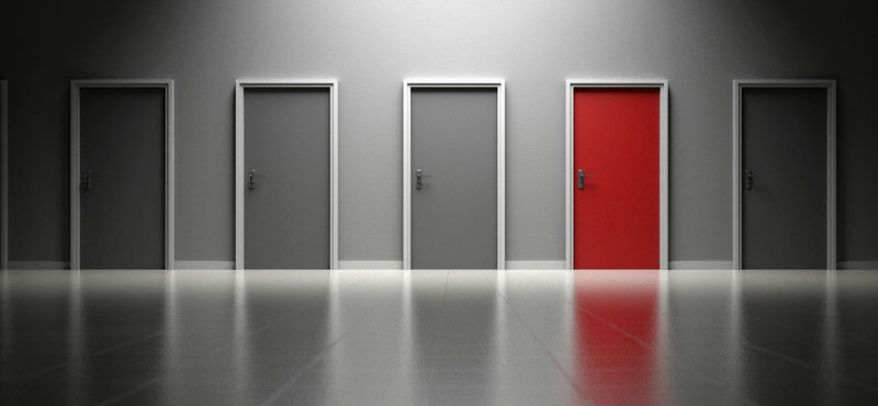 Mehrere gleiche Türen, eine davon ist rot, die anderen grau. (c) Pixabay.com