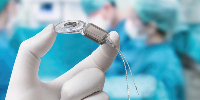 Schwerhörigkeit ist mittlerweile besser behandelbar als je zuvor 2 Eine Hand eines Arztes in einem OP-Saal, der ein Cochlear Implantat hält. (c) Cochlear Ltd.