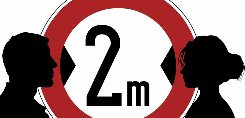 Die Silhouette eines Mannes und einer Frau vor einem "2m Abstand" Schild.
(c) Pixabay.com