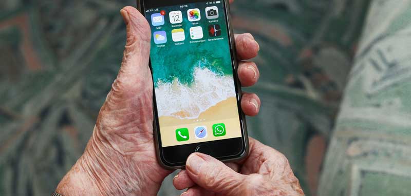 Die Hände einer alten Frau, die ein iPhone hält. (c) Pixabay.com