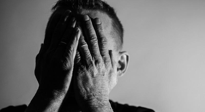 Ein Mann, der sich mit seinen Händen sein Gesicht zuhält, Stichwort psychische Gesundheit.
(c) Pixabay.com