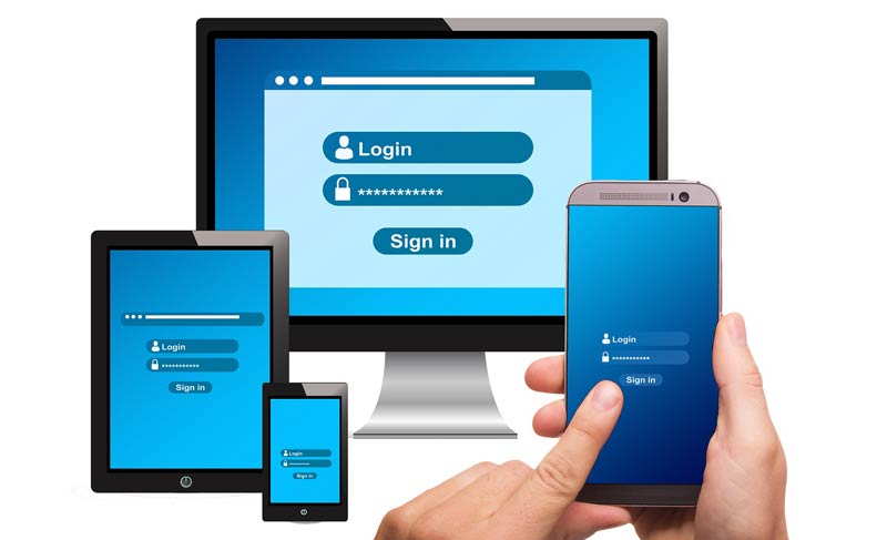 Die Hände eines Mannes, der sich auf seinem Smartphone einloggt, dahinter elektronische Devices mit Login-Screens, Stichwort Passwortsicherheit.
(c) Pixabay.com