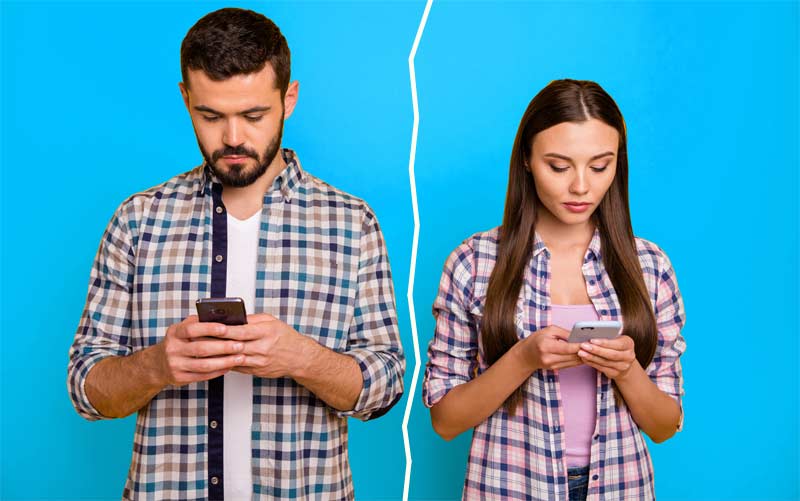 Ein Mann und eine Frau stehen nebeneinander und schauen beide in ihr Smartphone, Stichwort Online-Dating.
(c) AdobeStock