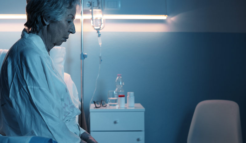 Mangelernährung bei Älteren erhöht das Risiko für Pflegebedürftigkeit 1 Eine ältere Frau alleine in einem Krankenzimmer auf einem Bett sitzend, Stichwort Mangelernährung.
(c) AdobeStock