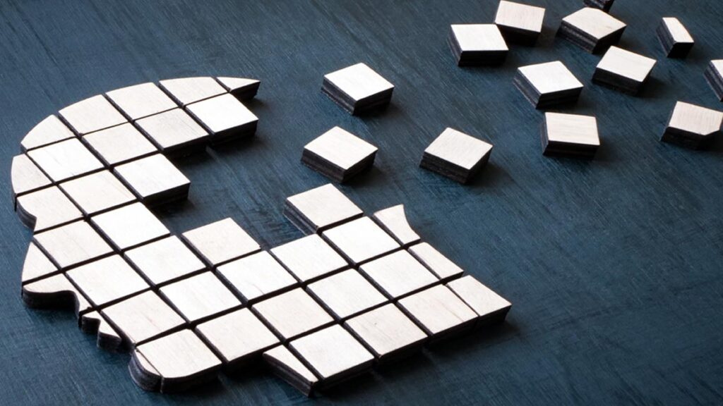 Grafik: der Umriss eines Kopfes mit quadratischen Holzteilen, von denen einige nach hinten "wegfliegen". (c) AdobStock