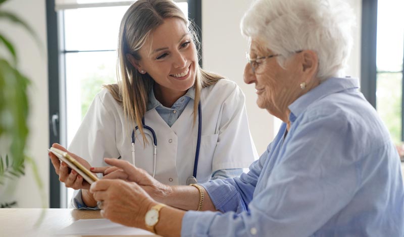 Evidenz auf Augenhöhe: Wie die Generation 50+ medizinische Studien liest 2 Ärztin zeigt einer älteren Patientin medizinische Daten auf einem Tablet für mehr Evidenz auf Augenhöhe.(c) AdobeStock