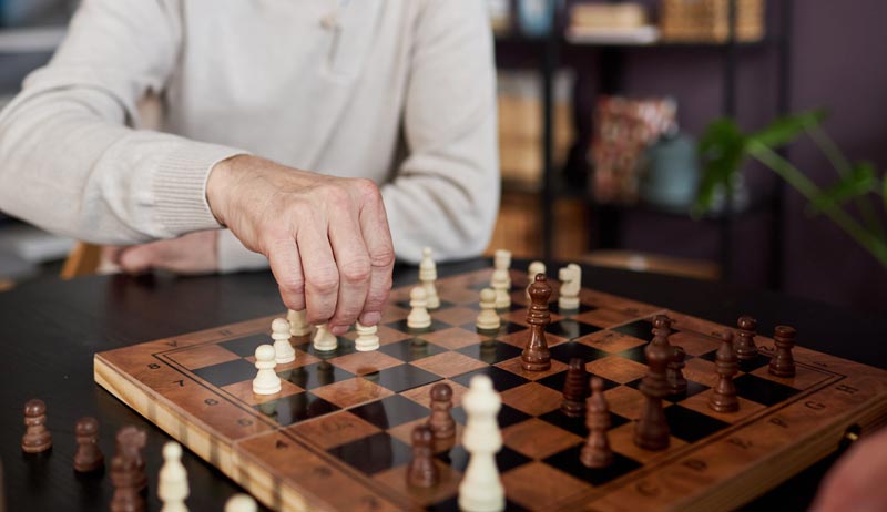 Alzheimer-Prävention und Demenz-Therapie: Fakten statt Esoterik-Zauber 1 Älterer Mann konzentriert beim Schachspiel zur Stärkung der kognitiven Reserve, Stichwort Alzheimer-Prävention.(c) AdobeStock